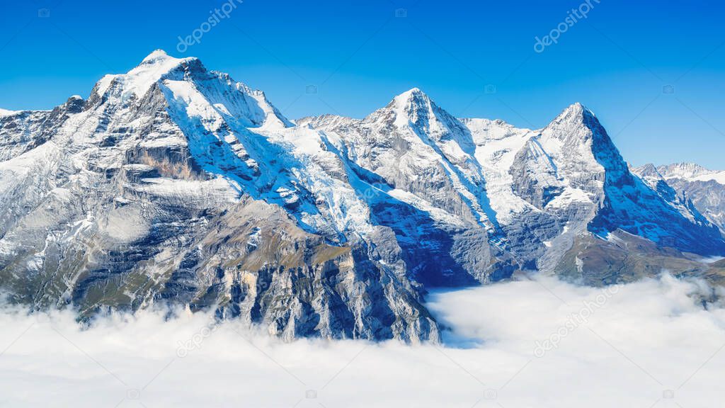 Mountain scenery in the Swiss Alps. Mountains peaks. Natural landscape. Mountain range and clear blue sky. Landscape in the summertime. 