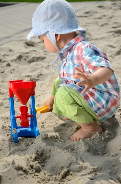 Baby boy in sandpit