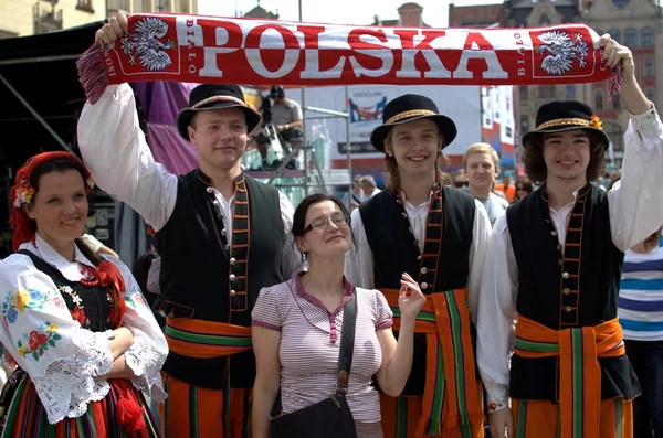 Folk dancers with football fan — Stock Photo, Image