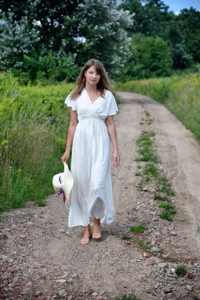 三十多岁的年轻女子的户外照片 波兰的夏季 在土路上的女人 图库图片