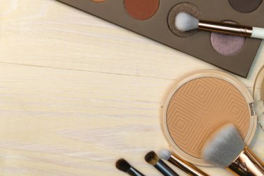 Nude Makeup Products Powder Brushes Palette wood background