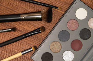 Smokey Eye Makeup Brushes and Palette wood background