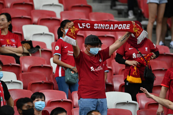 KALLANG, SINGAPORE - 15TH JULY, 2022: Unidentified fans of Liverpool in action during pre-season against Crystal Palace at national stadium