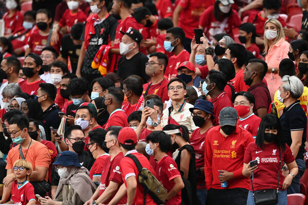 KALLANG, SINGAPORE - 15TH JULY, 2022: Unidentified fans of Liverpool in action during pre-season against Crystal Palace at national stadium