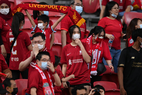 KALLANG, SINGAPORE - 15TH JULY, 2022: Unidentified fans of Liverpool in action during pre-season against Crystal Palace at national stadium