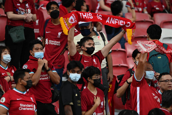 KALLANG, SINGAPORE - 15TH JULY, 2022: Unidentified fans of Liverpool in action during pre-season against Crystal Palace at national stadium