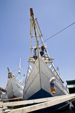 Makassar schooners (pinisi) in Sunda Kelapa clipart