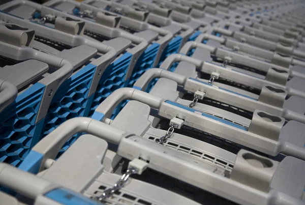 Blue plastic shopping carts in a row — Stock Photo, Image