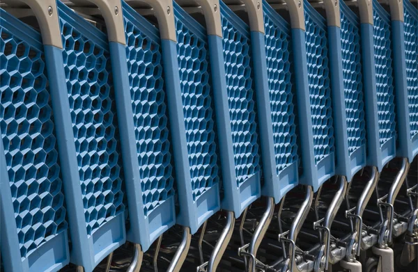 Blue plastic shopping carts in a row — Stock Photo, Image