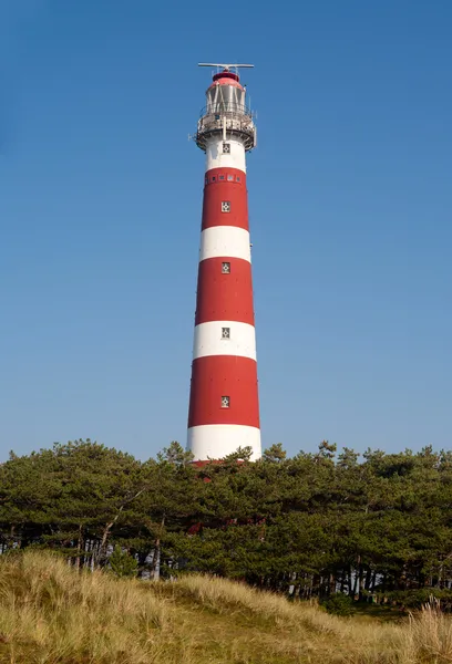 Iconic red and white lighthouse in the dunes of Ameland, the Netherlands — Stock Photo, Image