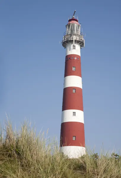 Iconic red and white lighthouse in the dunes of Ameland, the Netherlands — Stock Photo, Image