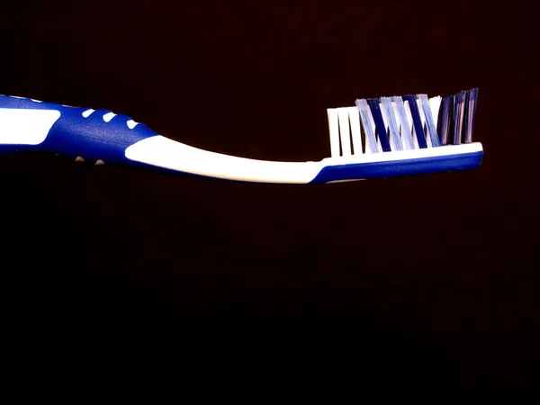 Tooth brush against black background — Stock Photo, Image