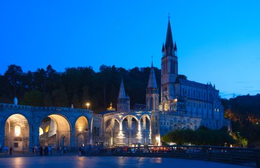 Rosary Basilica at night during the Torchlight Procession clipart