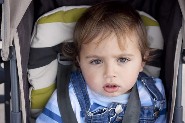 Toddler strapped up in stroller — Stock Photo, Image