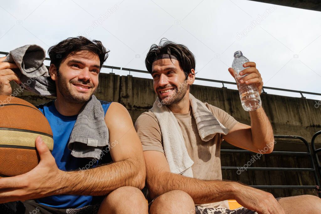 Two causian basketball player resting and ralax. 