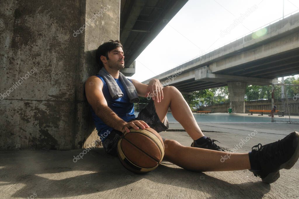 Young causian basketball player resting and ralax. 