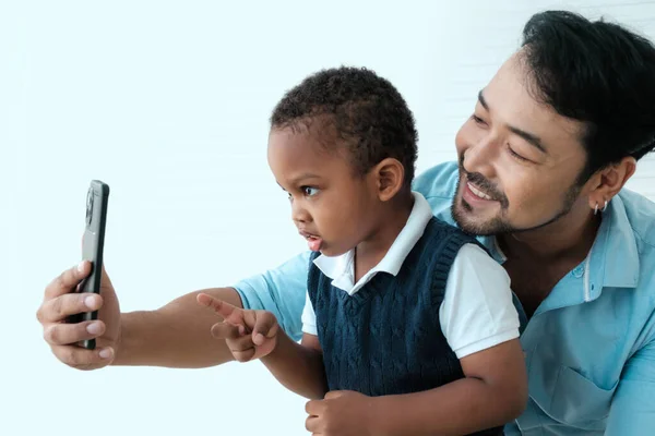 Daddy and son take a photo together.