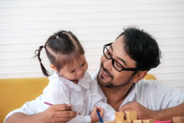 Father and daughter spending times on weekends to playing together.