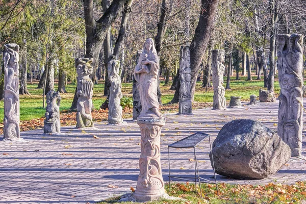 Autumn alley of chimeras with statues of monsters in the park of the city of Lutsk (Ukraine).