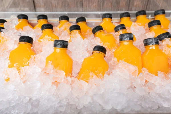 food and drink, orange juice in a bottle with ice