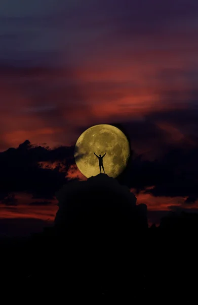 上昇満月に対して男 silhouettet ロイヤリティフリーのストック画像