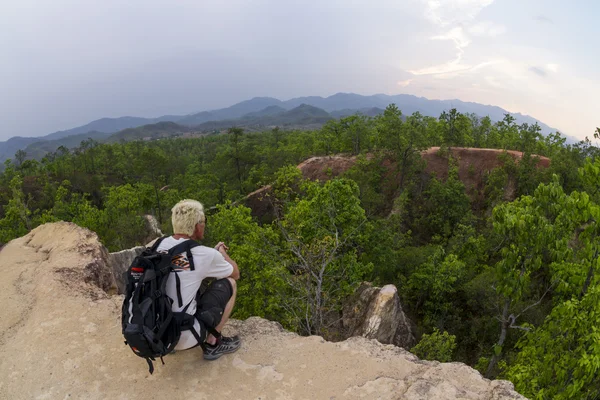 Hombre de senderismo y correr en las montañas con camisa blanca y mochila — Foto de Stock