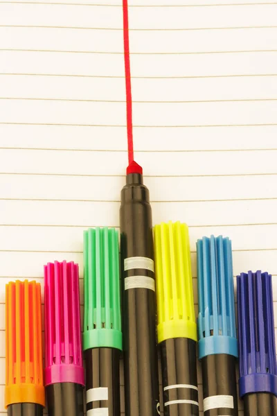 Collection of color pens on white paper with lines — Stock Photo, Image