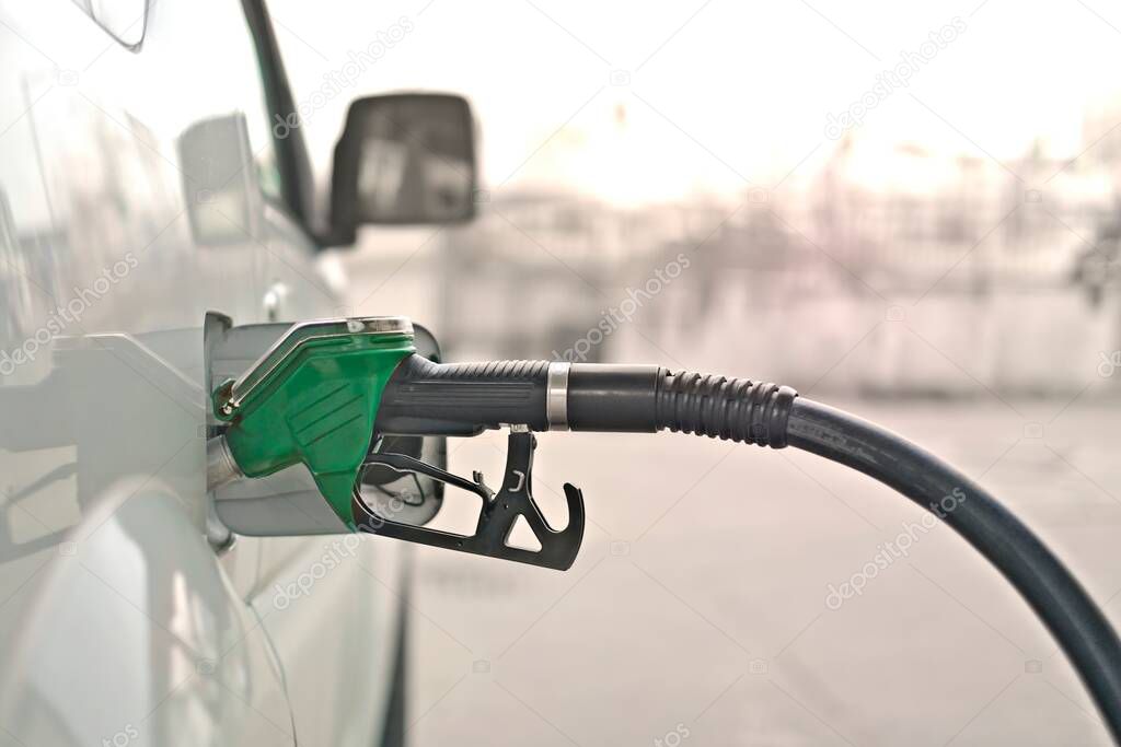 Refilling an car with fuel at the gas station. Horizontal image with copy space.