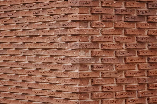 Red brick wall corner background texture.