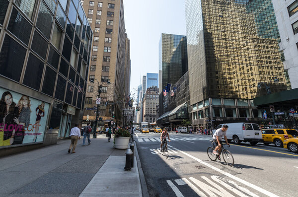 NEW YORK CITY - JULY 12: Cyclists and cars drive down 42nd street on July 12, 2012 in New York. Manhattan is a major commercial, economic, and cultural center of the United States.