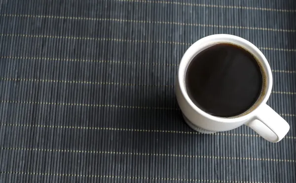 Cup of coffee on bamboo napkin — Stock Photo, Image