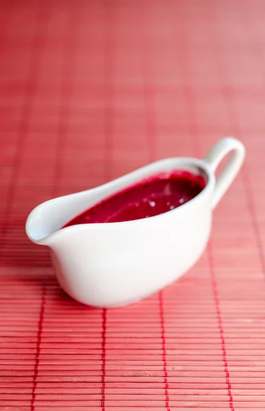 Sauce boat with red sauce Stock Image
