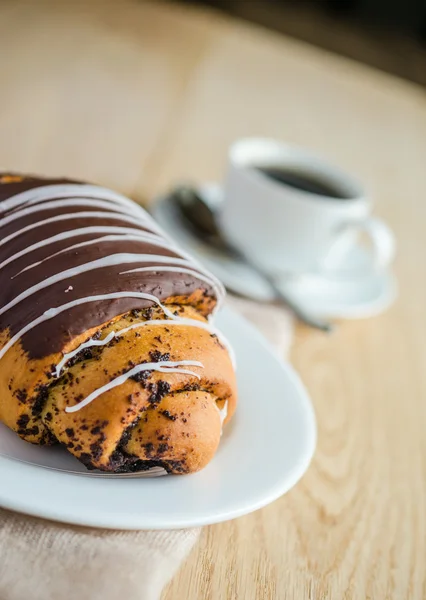 Chocolate bun with cup of coffee — Stock Photo, Image