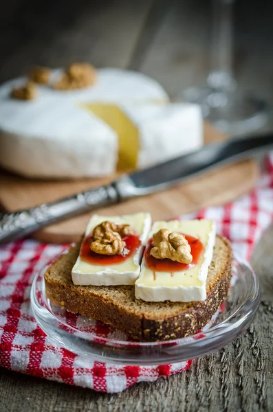 Sliced camembert on the bread — Stock Photo, Image