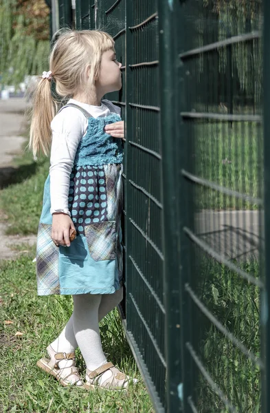 Girl watching a game on the playing-field — Stock Photo, Image