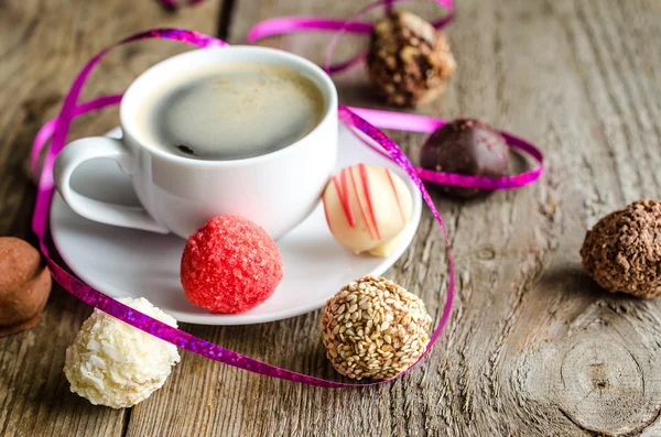 Luxury chocolate candies and cup of coffee — Stock Photo, Image