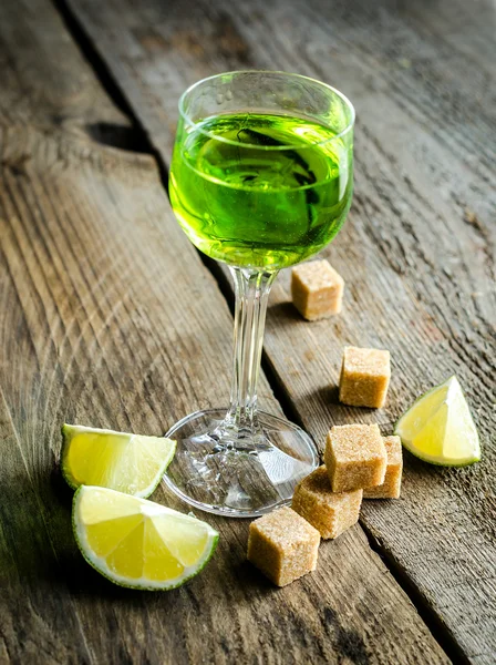 Glass of absinthe with lime and sugar cubes — Stock Photo, Image