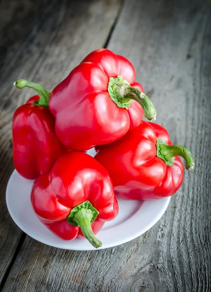 Red bell peppers on the wooden background Stock Picture