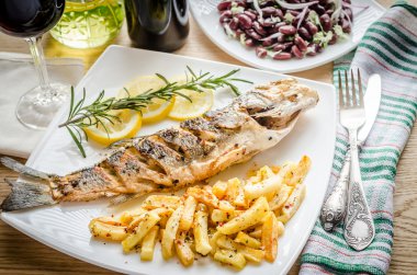 Baked seabass with fried potatoes clipart