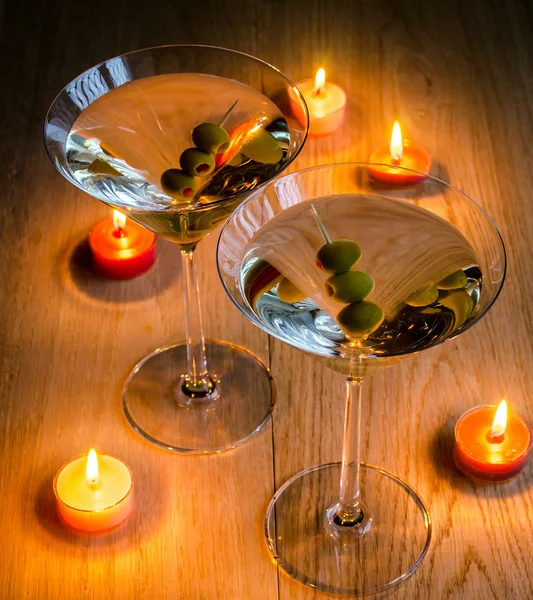 Two olive martini cocktails in the candlelight — Stock Photo, Image