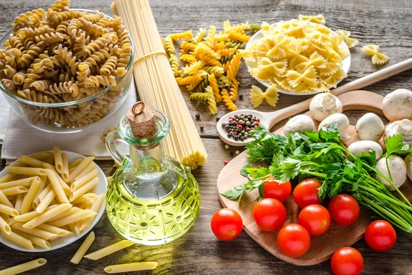 Various types of pasta with mushrooms and cherry tomatoes — Stock Photo, Image