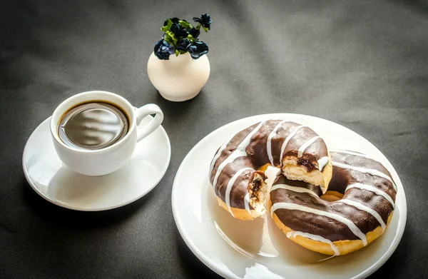 Chocolate donuts with a cup of coffee — Stock Photo, Image