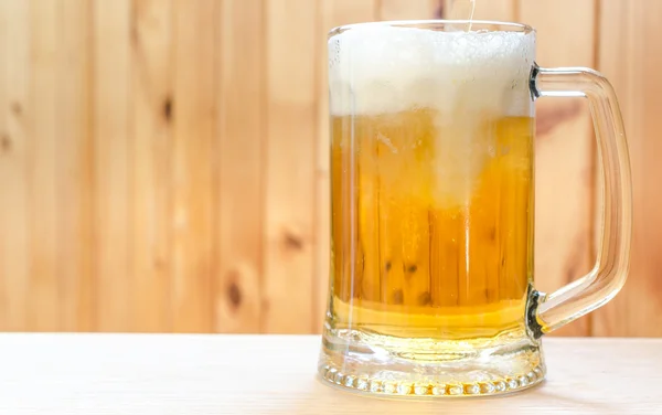 Beer pouring into mug — Stock Photo, Image