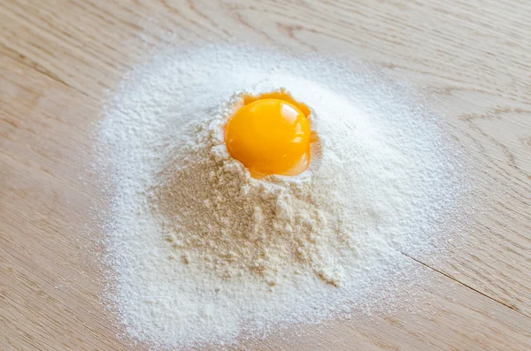 Broken egg in flour — Stock Photo, Image