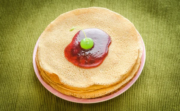 Crepes under cherry topping — Stock Photo, Image
