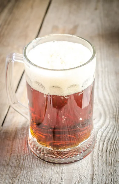 Mug with dark beer on the wooden table — Stock Photo, Image