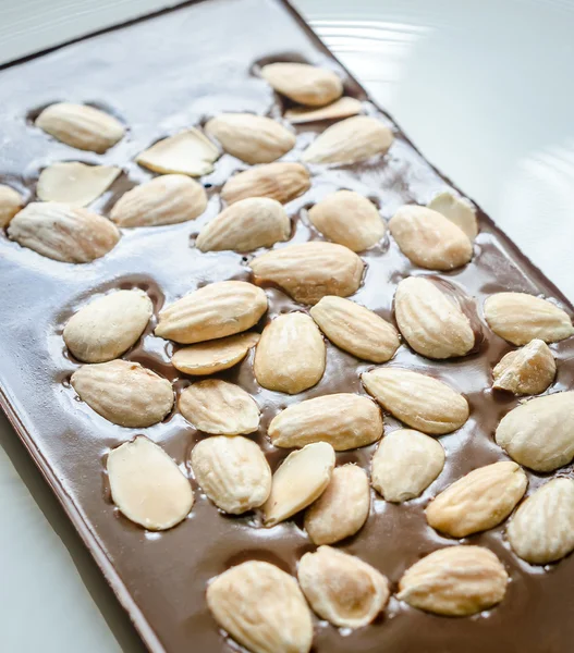 Luxury chocolate bar with whole almonds — Stock Photo, Image