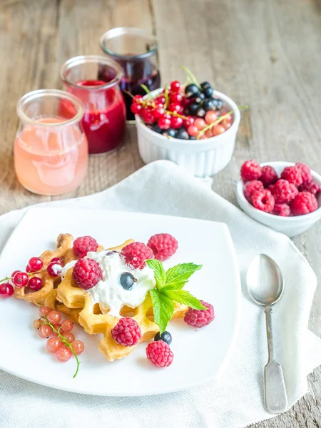 Belgian waffles with whipped cream and fresh berries Royalty Free Stock Images