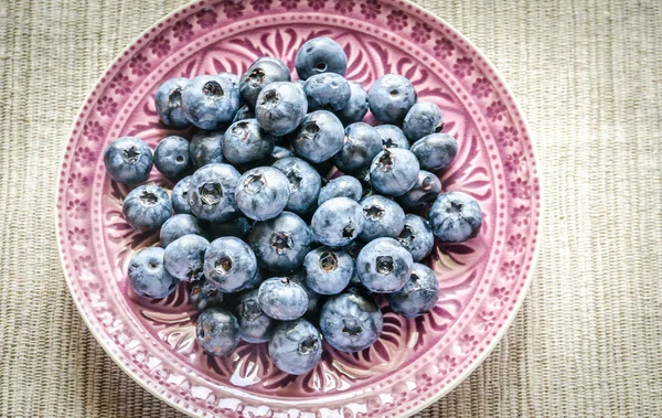 Fresh blueberries on the decorated plate — Stock Photo, Image