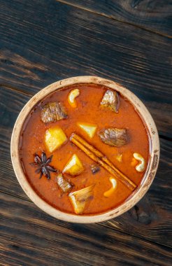 Bowl of Massaman curry on the wooden background